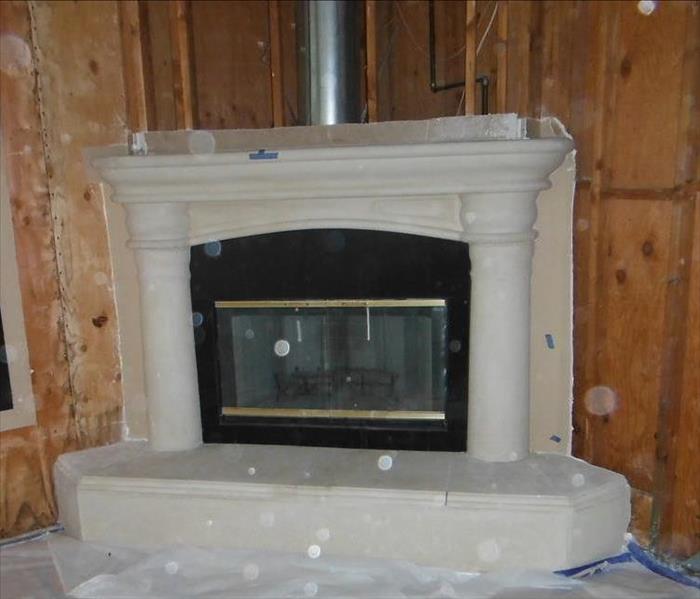 Demolition of surrounding drywall and plaster around this fireplace was necessary due to a roof leak