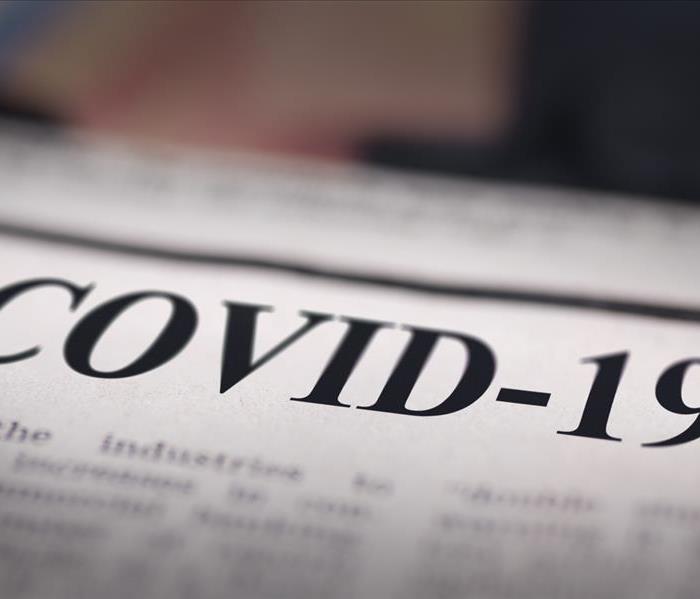 A newspaper with the headline saying: COVID-19